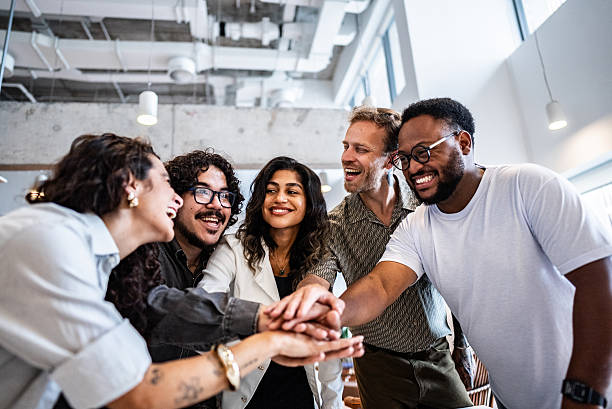 istock Coworkers with hands clasped at the office 2209261007