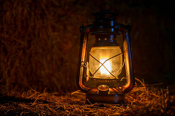 istock antique kerosene lamp with lights on a haystack in a barn at night 2209261551