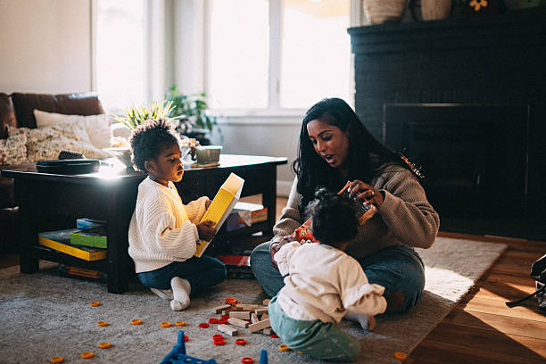 istock Woman at home playing with her young daughters 2209270037