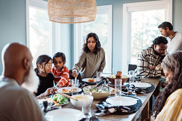 Multiracial multi-generation family enjoying holiday dinner together
