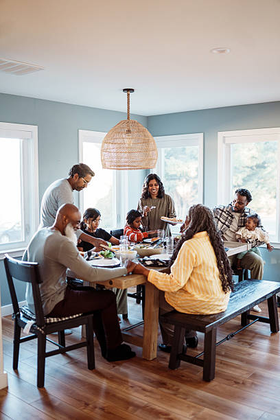 Multiracial multi-generation family enjoying home cooked dinner together