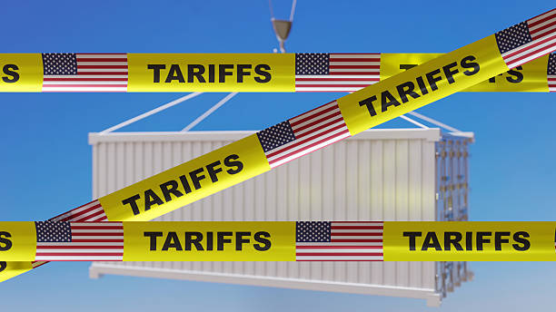 istock Tariffs text and US flag on yellow tape. Import tariff increase, Trade war concept 2209270368