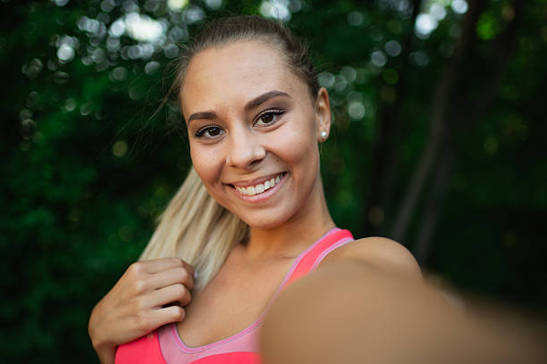 istock Smiling woman taking selfie in nature 2209270569
