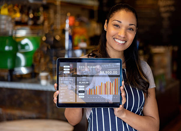 istock Cafe owner showing the growth in her business finances using a tablet 2209273716