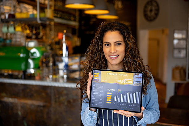 istock Cafe manager showing growth in her business using a digital tablet 2209273734
