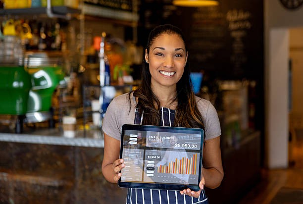 istock Coffee shop manager showing good results for her business using a digital tablet 2209273737