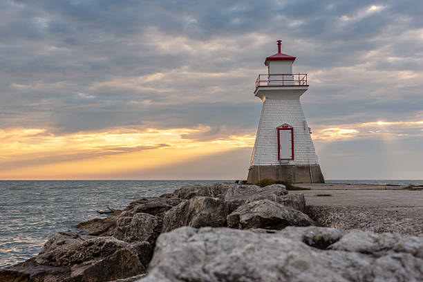 istock Saugeen River lighthouse in front of Lake Huron sunset 2209274156