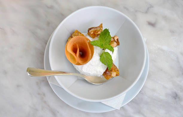 Fresh Coconut Ice-cream served with cone and peanut bar, decorated with mint.