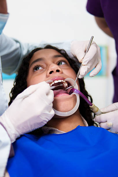istock Dentist performing dental check-up on young patient's teeth 2209279358