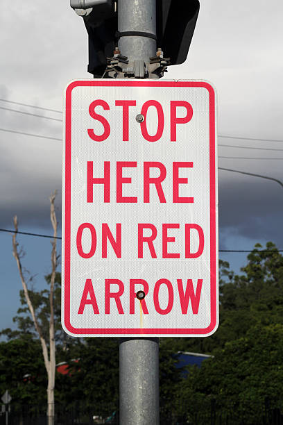 istock Stop Here On Red Arrow road sign attached to a traffic light pole 2209286161