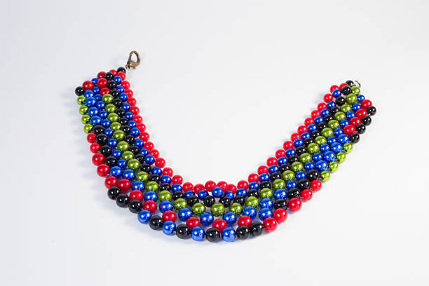 Handmade colorful necklace made of plastic beads in ethnic and boho style on a white background.