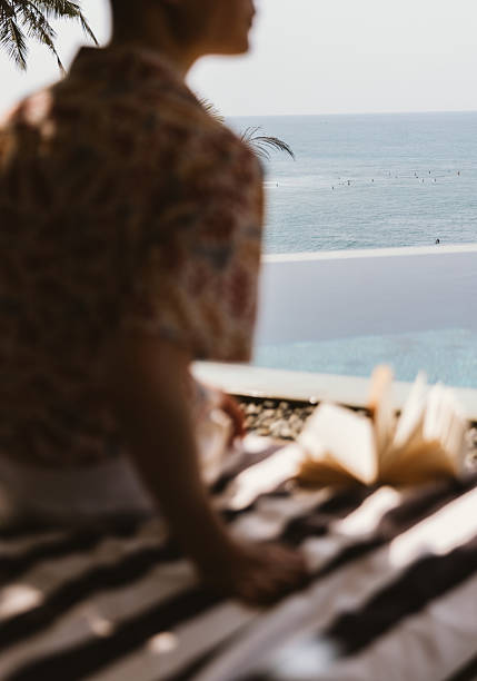 little girl swims in the sea with swimming muscles, cap and swimsuit alone, she is happy, have a nice day