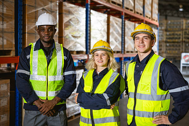 istock group professional warehouse worker. stock inventory team staff employee working in cargo storage 2209295450