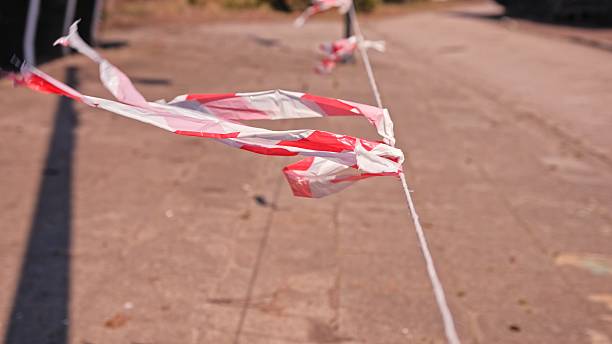 istock Fire Prevention and Protection Red and White Safety Flagging Tape Blowing in Wind 2209295656