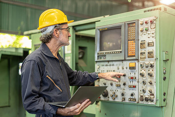 istock Senior Professional technician engineer male operate control heavy industry machine CNC in factory. 2209295802