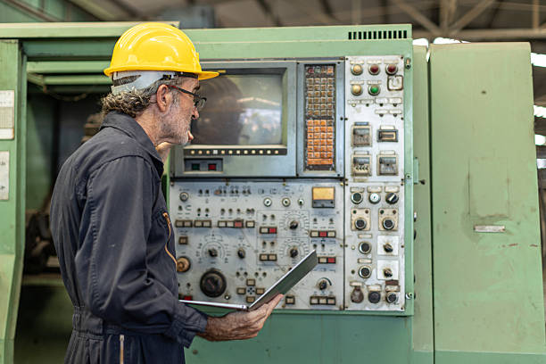istock Senior Professional technician engineer male operate control heavy industry machine CNC in factory. 2209295819