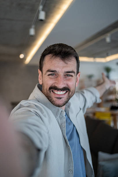 istock Happy entrepreneur taking a selfie in his modern office 2209296992
