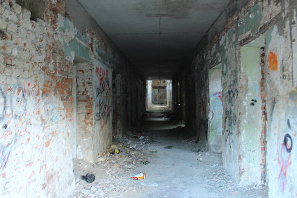 istock A dark corridor in an abandoned building. Destroyed houses 2209299788