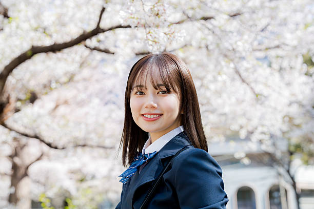 istock High school girl walking in the cherry blossoms 2209301949