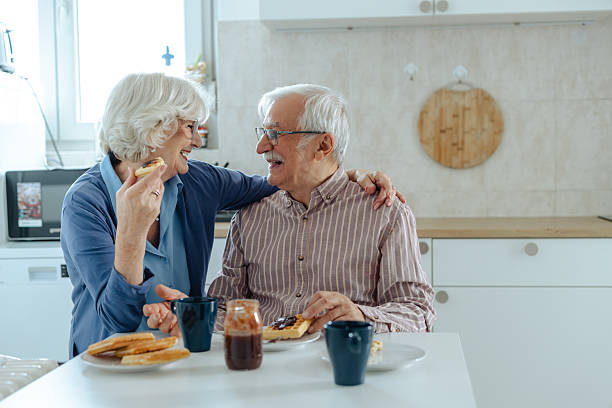 istock Senior couple enjoying breakfast together in a cozy modern kitchen 2209304092