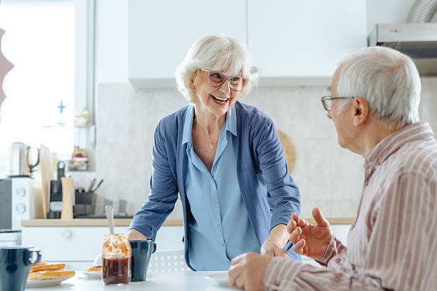 istock Elderly couple sharing breakfast together in a bright kitchen 2209304105