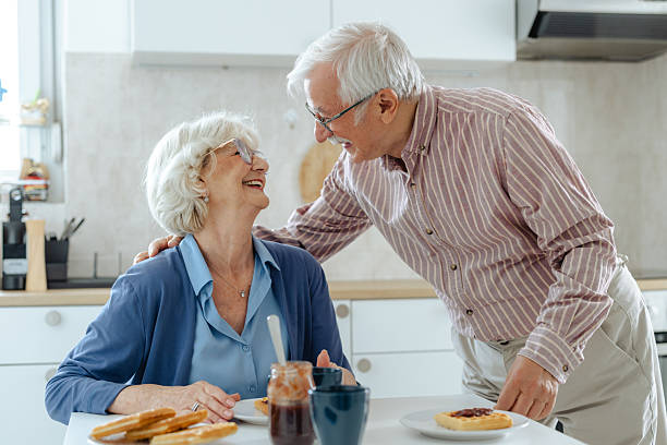 istock Elderly couple sharing a joyful moment together in a cozy kitchen setting 2209304197