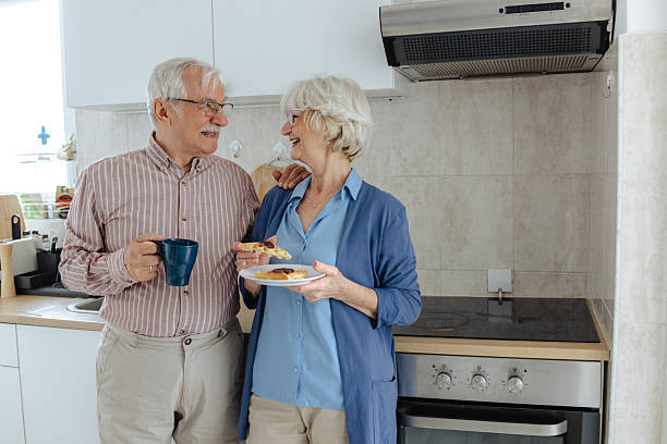 istock Senior couple enjoying breakfast together in a cozy home kitchen 2209304273