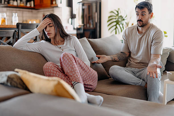 istock Young couple arguing on the sofa at home 2209307884