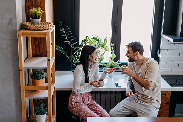 istock Young couple enjoying a relaxing morning coffee in their modern kitchen 2209307992