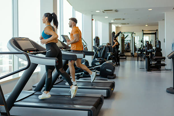 istock Cardio Partners: Fitness Enthusiasts Training Together in Modern Gym 2209310555