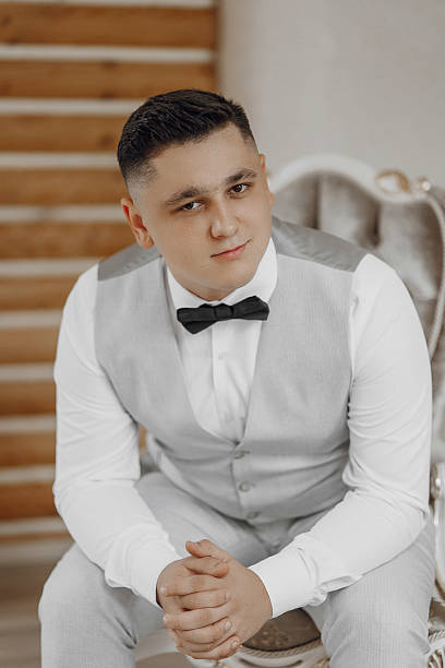 istock A man in a suit and tie is sitting in a chair 2209311861