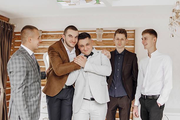 istock A group of men are hugging each other in a room 2209311900