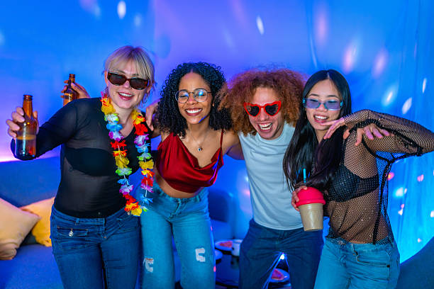 istock Young friends having fun and drinking at disco party 2209312930