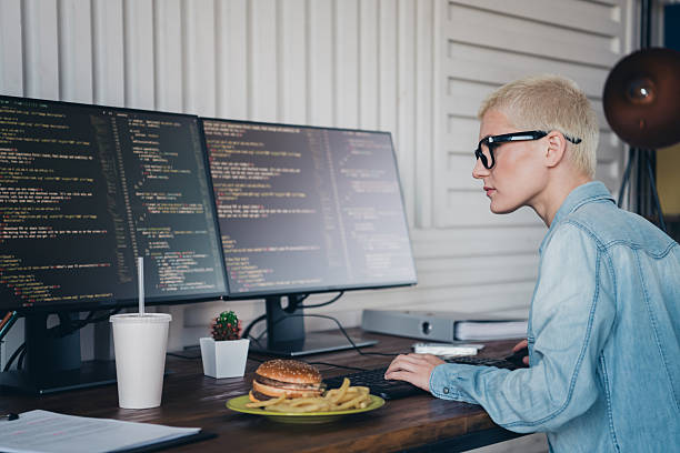 istock Young Woman Working on Programming Projects in a Casual Home Office Setup 2209314770