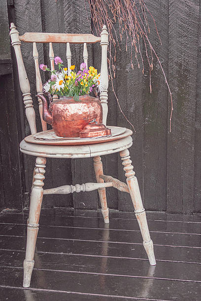 istock flower vase on vintage chair 2209319132
