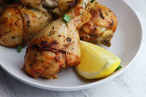 istock Grilled chicken. Spicy grilled chicken legs, drumsticks  on the white plate. 2209323197