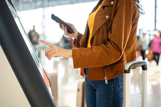 istock Close up the woman hands touching the screen while self check in kiosk technology machine getting boarding pass at the airport terminal 2209323824