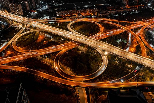 istock Aerial view of illuminated highway interchange at night. 2209324027