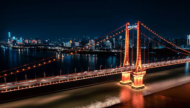 istock Illuminated bridge and city skyline at night 2209324105