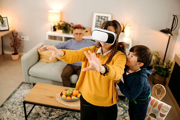 Mother and son playing in virtual reality glasses in living room
