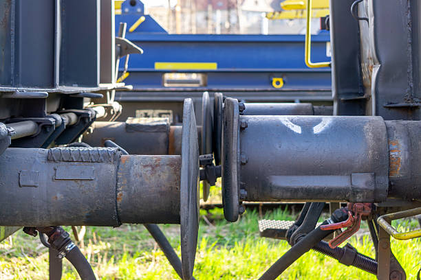 Metal handle device under the truck chassis, using as locking or release device for latching pin between truck cabin and trailer (Kingpin). Transportation safety object photo, selective focus.