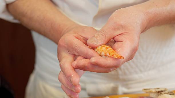 istock The hands of a chef preparing sushi 2209325800