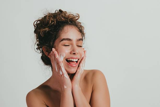 istock Woman Applying Face Cream with a Smile 2209326315