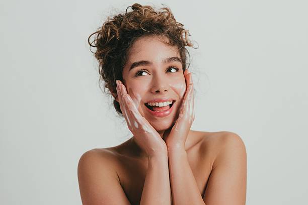 istock Woman Applying Face Cream with a Smile 2209326323