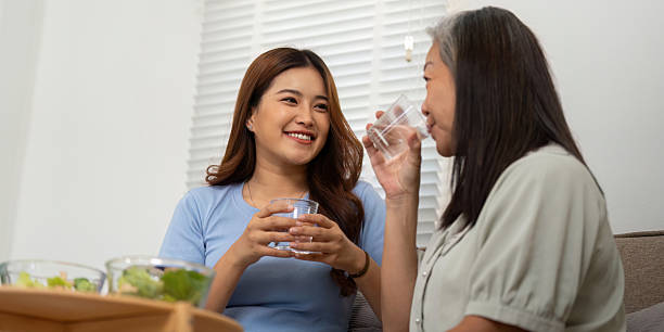 istock Conversation and Hydration. A mother and daughter savoring healthy drinks and shared moments. 2209327678