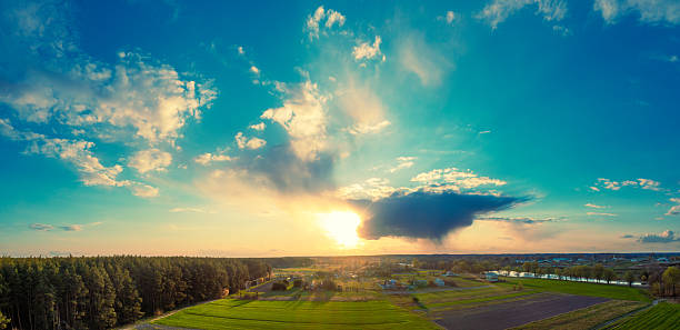 Panoramic view from above of countryside with arable fields at sunset