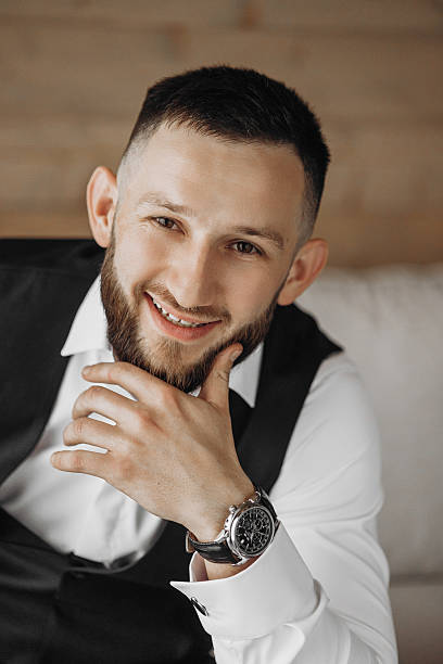 istock A man with a beard and a watch is smiling 2209330520