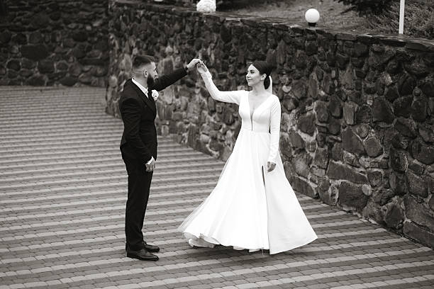 istock A bride and groom are dancing on a stone walkway 2209330663