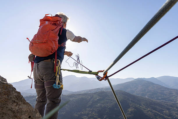 istock View down safety rope to climber on mountain top 2209330900