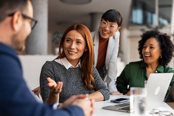 istock Group of Professionals Collaborating and Smiling in Office Meeting 2209334081
